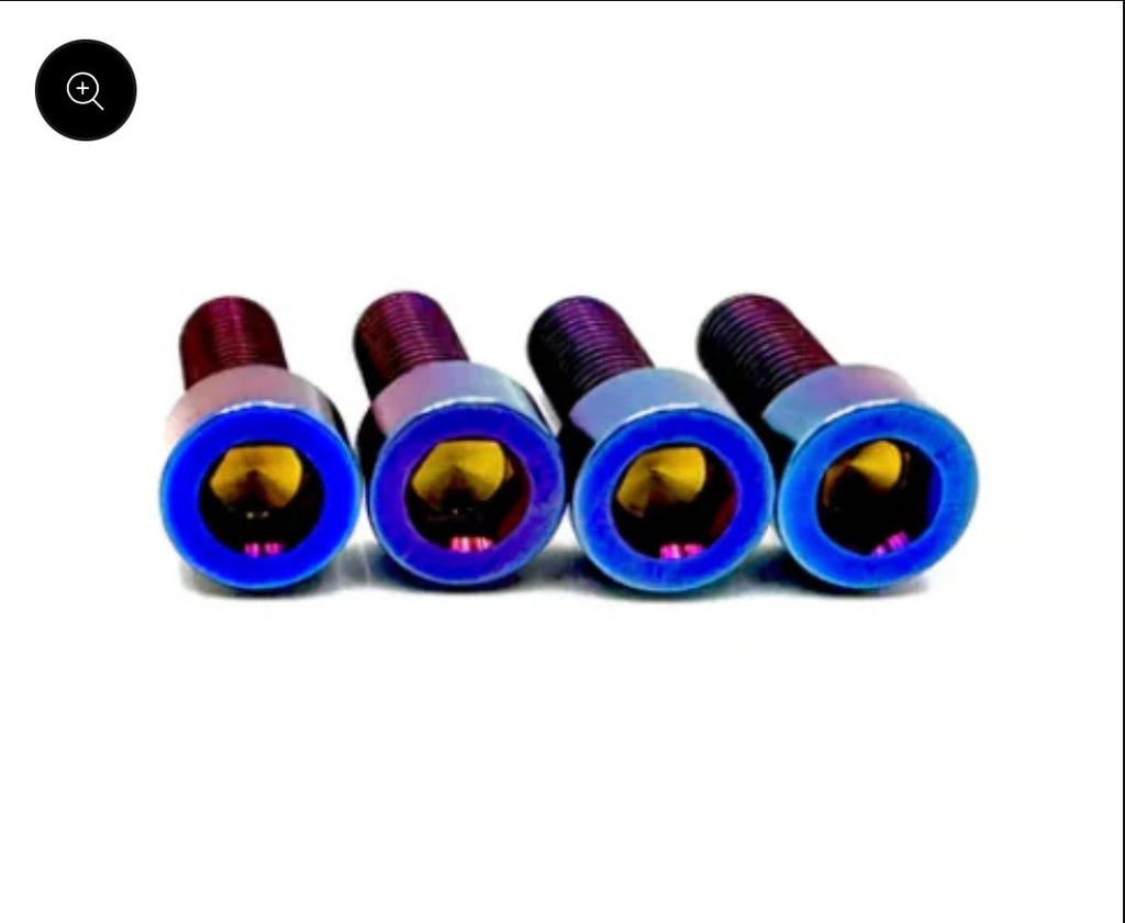 Four titanium bolts on white background